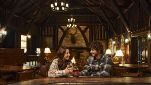 A rustic interior with wooden beams, a fireplace, and a bar area. - Pine Mountain State Resort Park (Pineville)