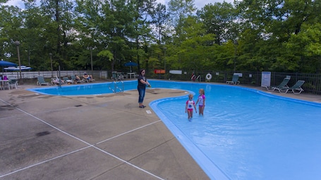 Outdoor pool, open 9:00 AM to 9:00 PM, pool umbrellas, sun loungers. Pine Mountain State Resort Park