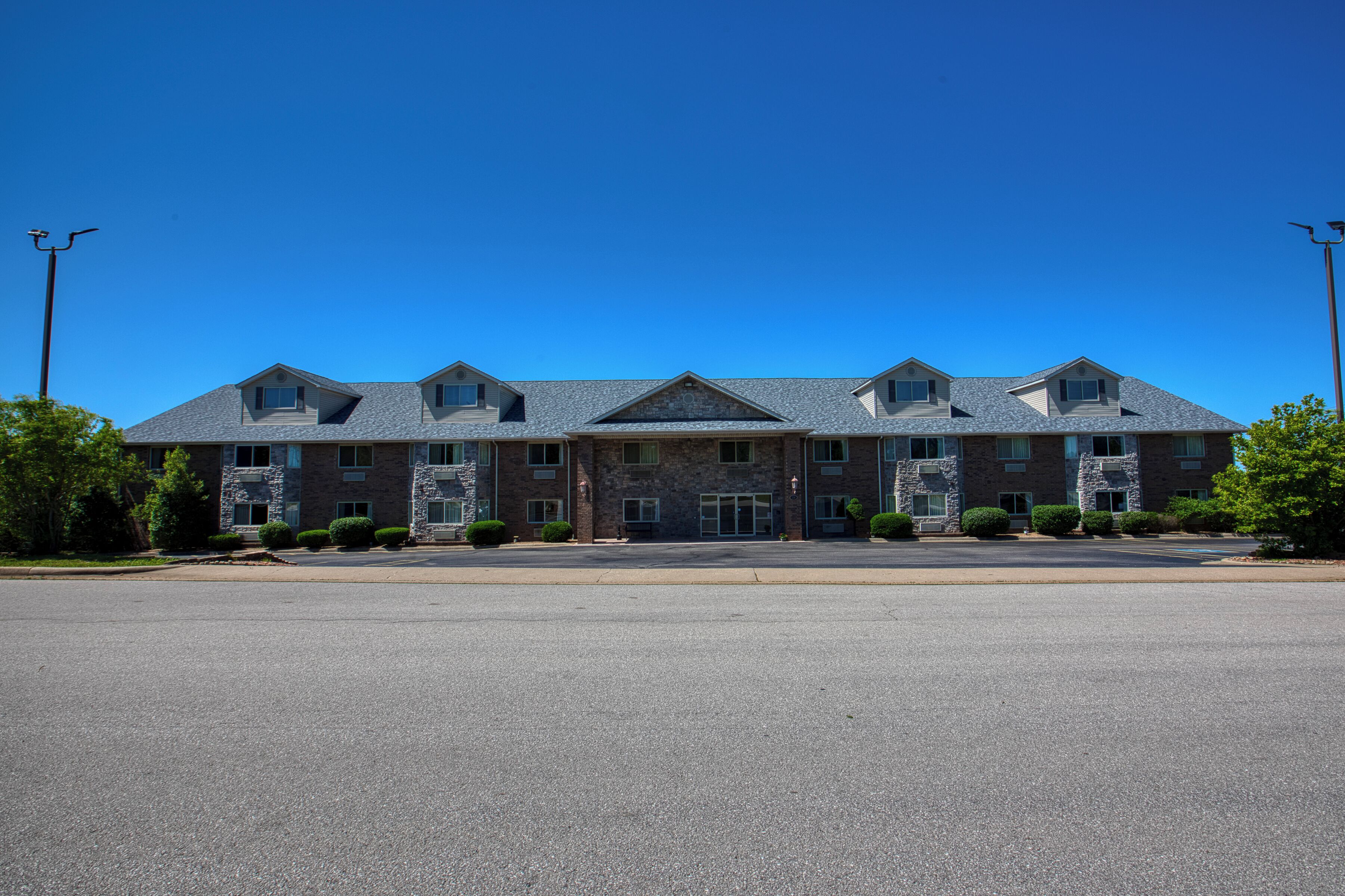 A large, multi-story building with a symmetrical facade, featuring a central entrance and multiple windows.