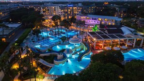 A resort with multiple swimming pools, a large building labeled 'Atlantis,' and a covered area with umbrellas. - Limak Atlantis De Luxe Hotel & Resort - All Inclusive (Serik)