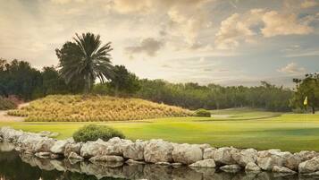 Stunning golf course views with a serene lake and lush greenery.