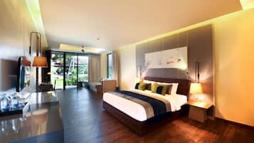 A modern hotel room with a large bed, bedside tables, a desk with a chair, and a view of the outdoors.