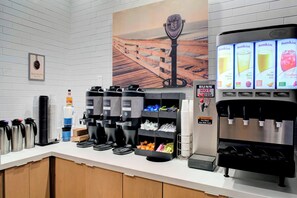 A coffee station with multiple coffee dispensers, a water cooler, and a juice dispenser. - Fairfield Inn & Suites by Marriott Virginia Beach Oceanfront (Virginia Beach)