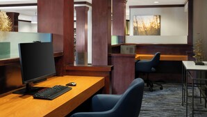 A modern office space with wooden desks, ergonomic chairs, and a large window with a view of trees. - Fairfield Inn & Suites by Marriott Tifton (Tifton)