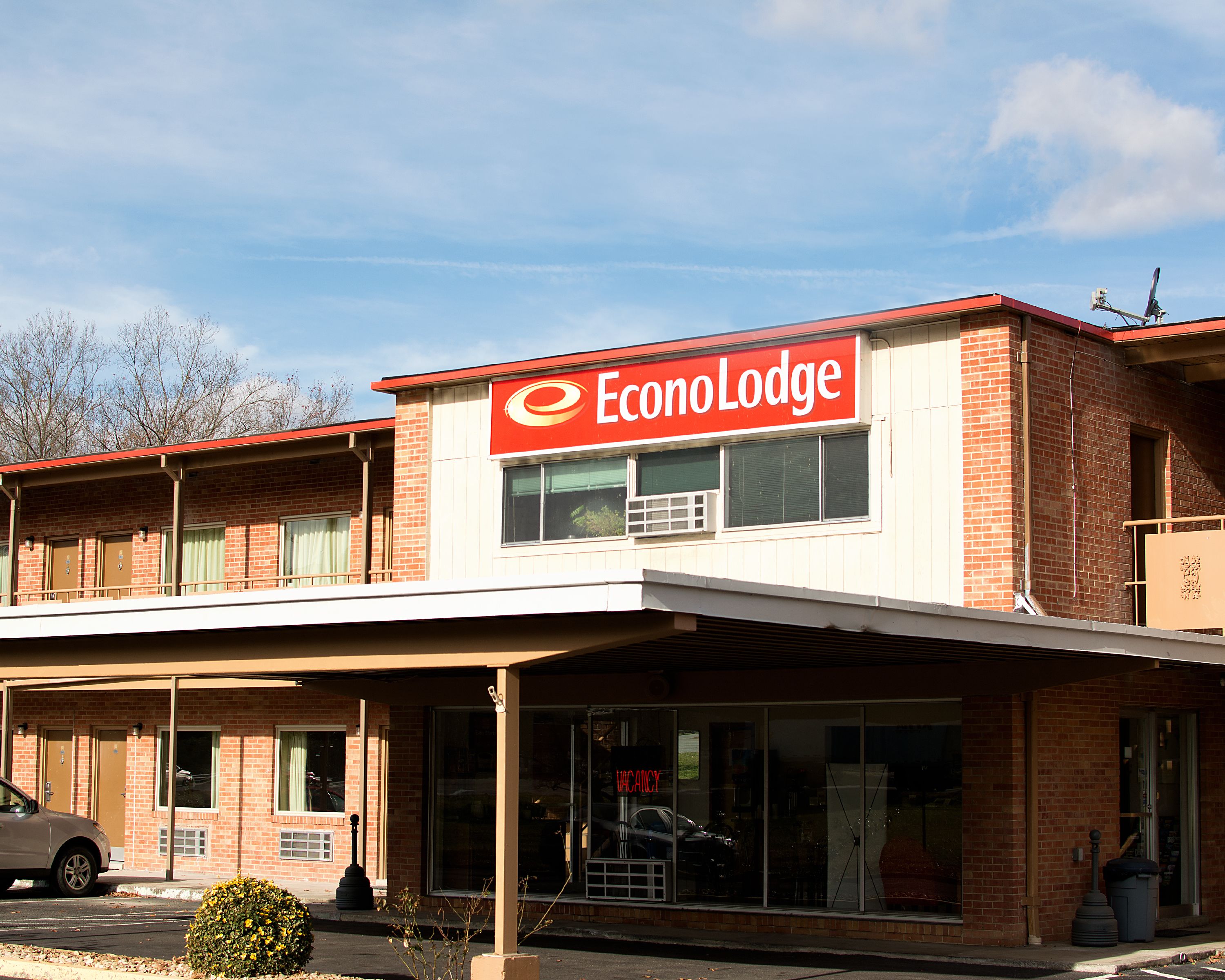 A two-story EconoLodge building with a red and white sign, brick facade, and a covered entrance area.