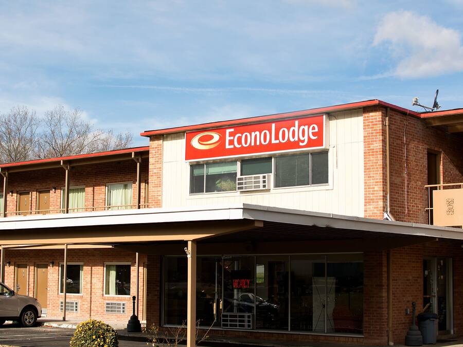 A two-story EconoLodge building with a red and white sign, brick facade, and a covered entrance area.