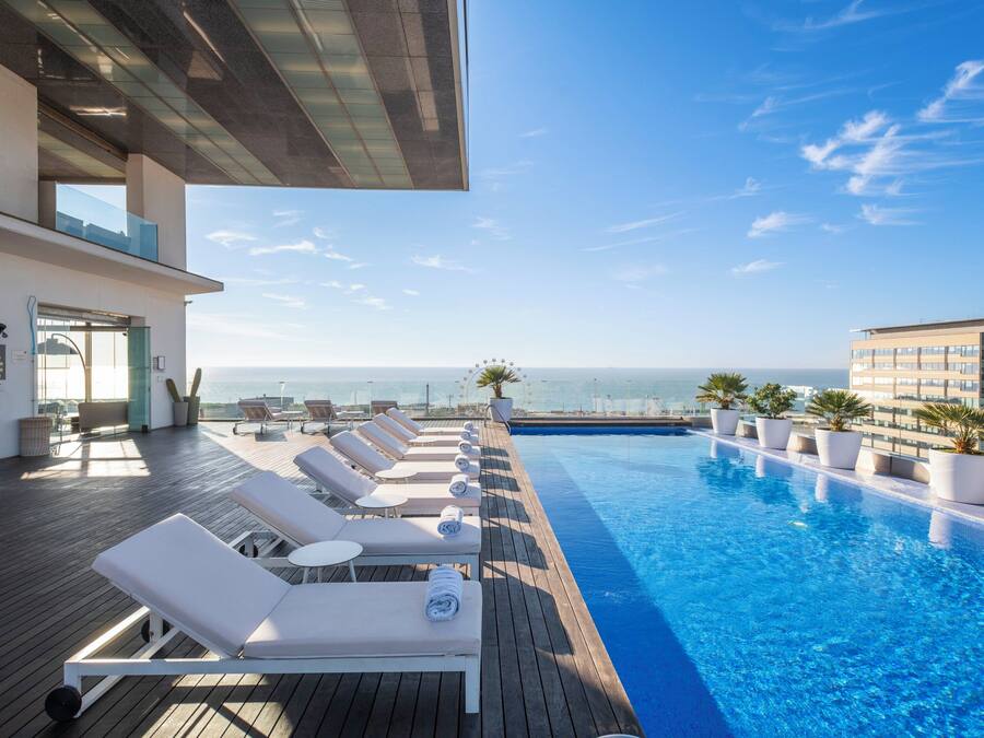 Una piscina al aire libre, tumbonas