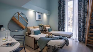 A modern hotel room with a bed, a desk, and a dining area. - Best Western Alba Hotel (Nice)