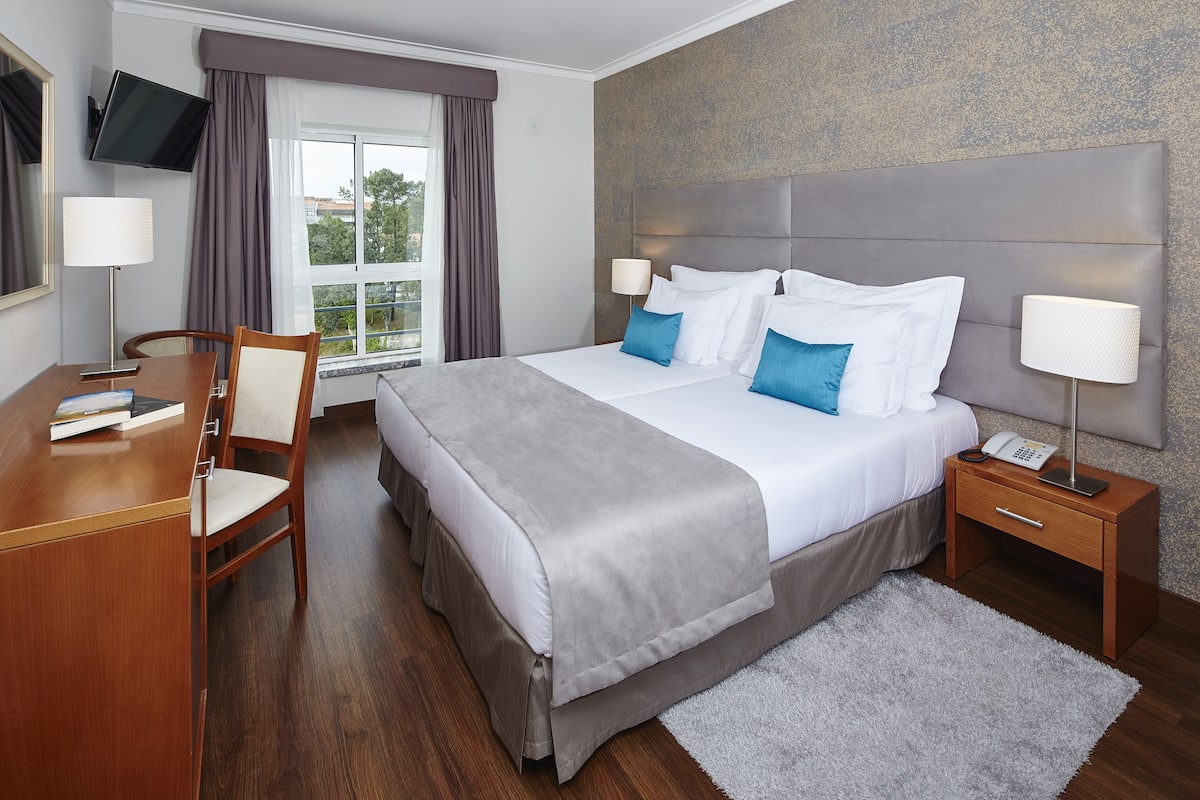 twin room | minibar, in-room safe, desk, blackout curtains