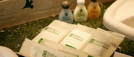 Toiletries and a tissue box on a bathroom counter.