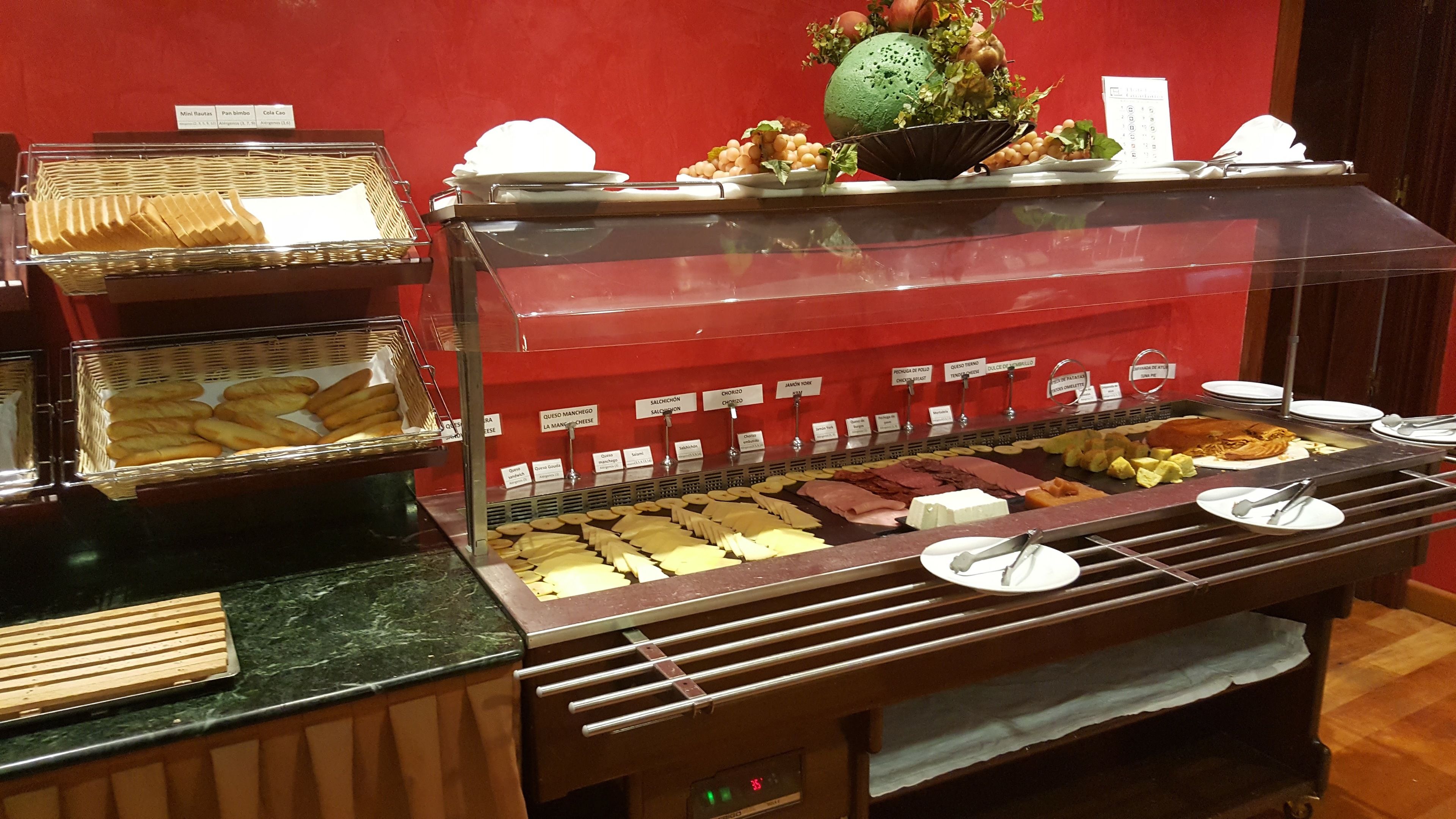 A buffet with various food items and a clock.