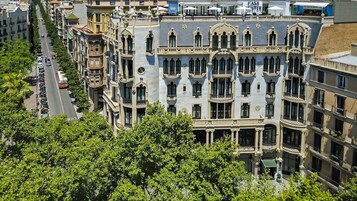 A multi-story building with ornate architectural details, including balconies and decorative moldings.