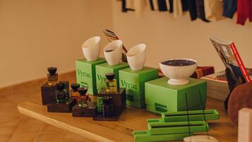 A wooden table with green boxes labeled 'Wyra', a white bowl, and various small containers.