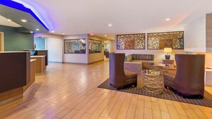 A spacious lobby with a reception desk, seating area, and decorative wall art. - Best Western York Inn (York)