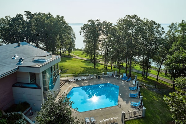 En säsongsöppen utomhuspool och solstolar