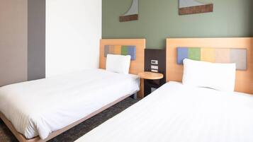 A hotel room with two single beds, a small round table, and a wall-mounted control panel.