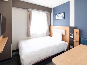 A hotel room with a bed, a desk, a TV, and a window with curtains. - Comfort Hotel Narita (Narita)
