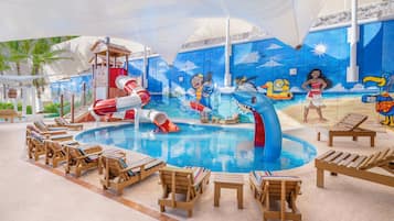 Relax by the pool surrounded by a vibrant mural and comfortable lounge seating.