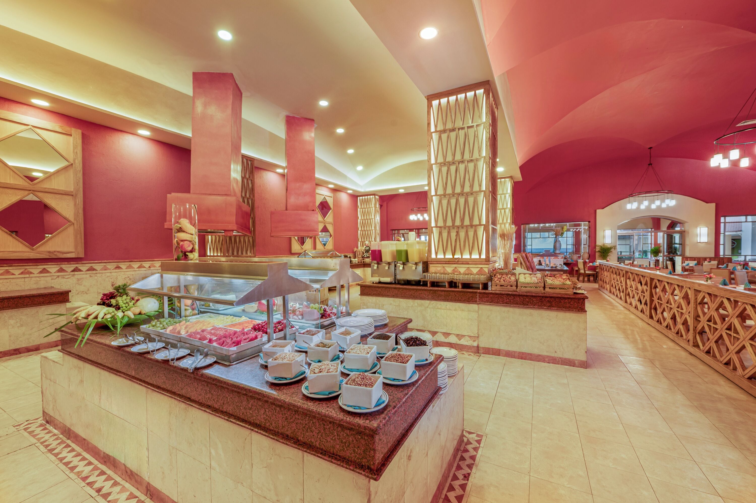 A buffet area with a variety of food items and a decorative wall.