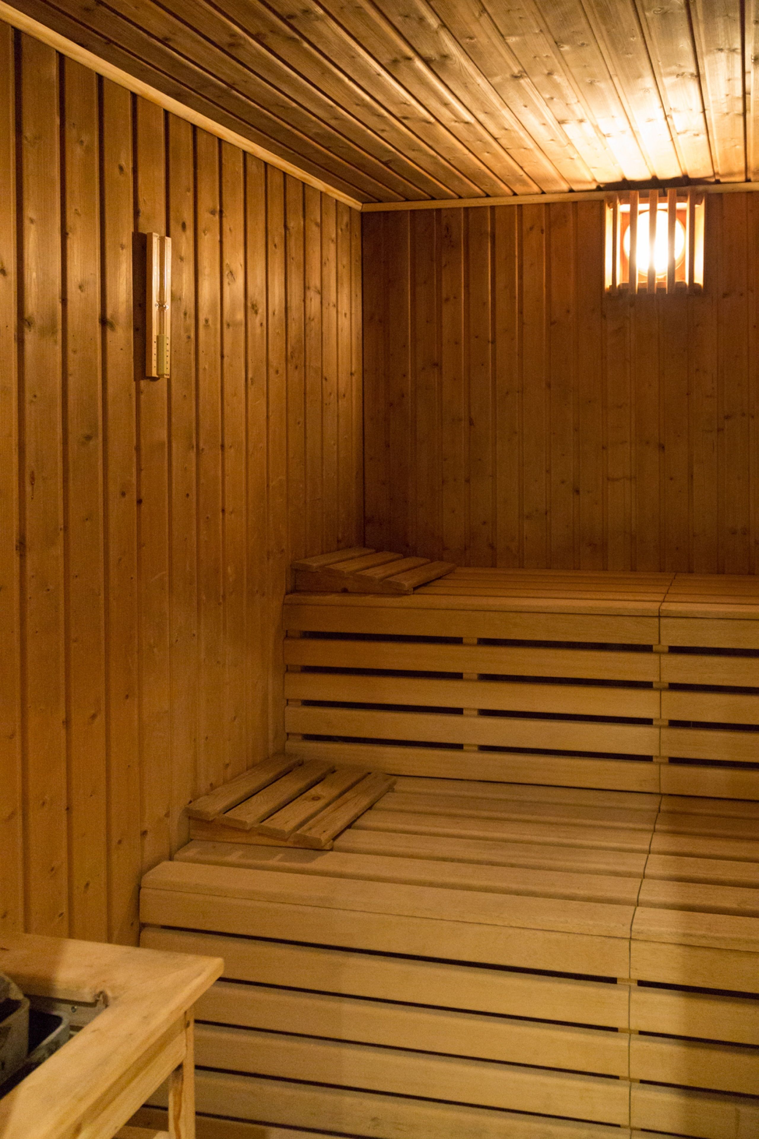 A sauna with wooden walls and benches.