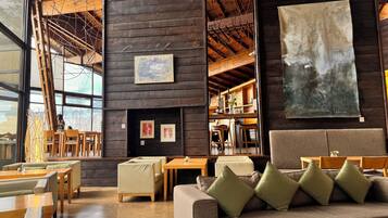 A cozy interior with wooden walls, a fireplace, and a large abstract painting.