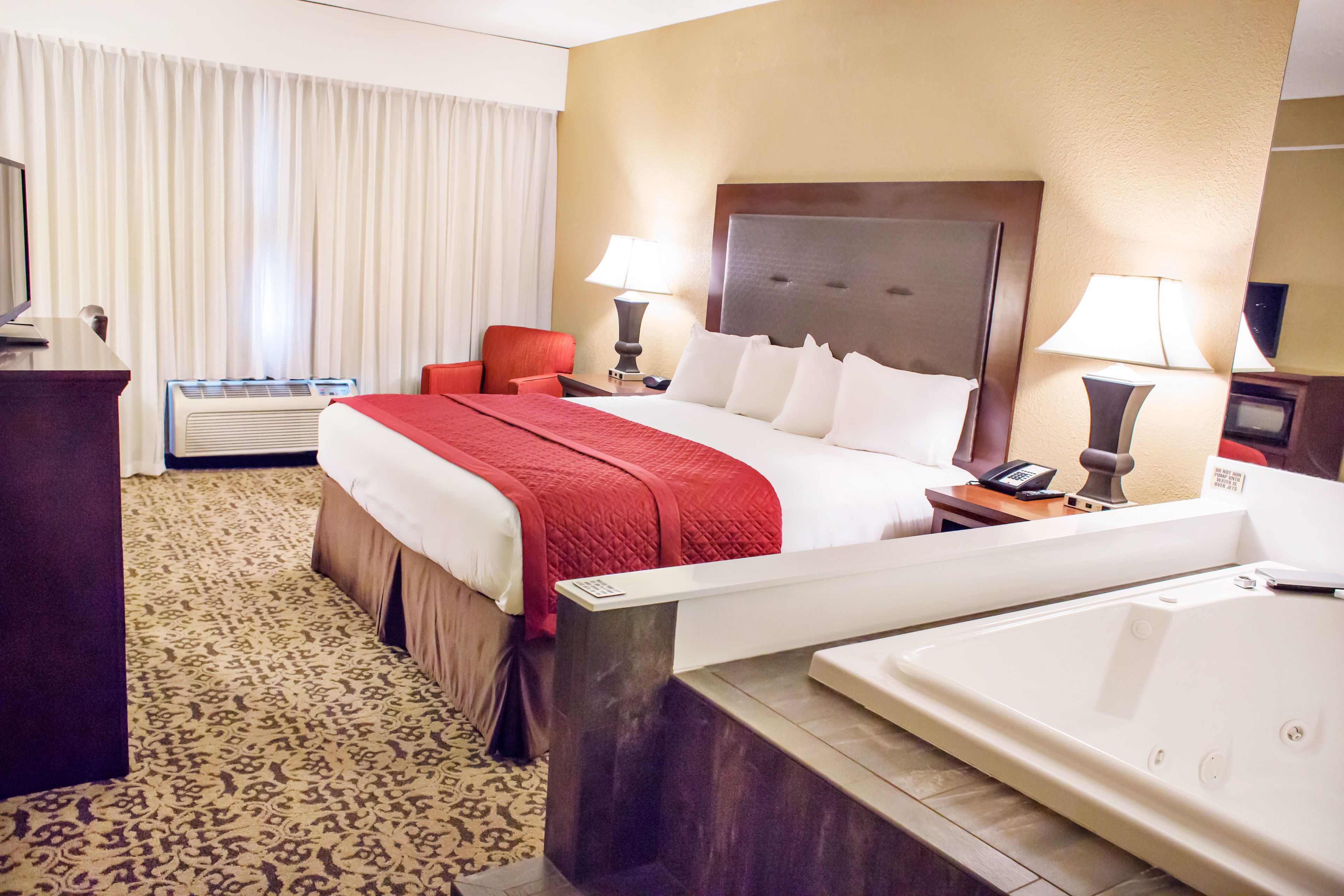 deluxe room, 1 king bed, jetted tub (2 person whirlpool) | premium bedding, desk, blackout curtains, iron/ironing board