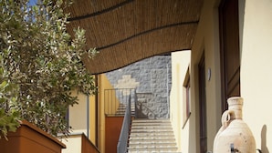 A staircase with patterned tiles leading to a building entrance. - Hotel A' Pinnata (Lipari)