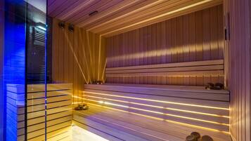 A modern sauna with wooden slats and warm lighting.