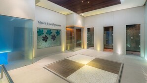 A modern lobby with a glass wall, a wooden ceiling, and a tiled floor with a floral pattern. - Grand Hotel Terme (Riolo Terme)