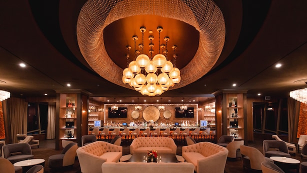 A bar area with a circular chandelier, sofas, and a bar counter. - Morongo Casino Resort Spa (Cabazon)