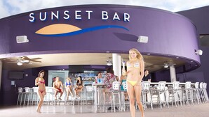 A sunset bar with a curved exterior, outdoor seating, and a pool area. - Morongo Casino Resort Spa (Cabazon)
