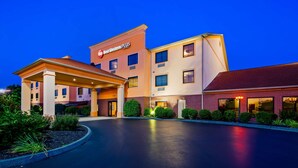 A hotel with a prominent Best Western Plus sign, a covered entrance, and a well-maintained landscaped area.