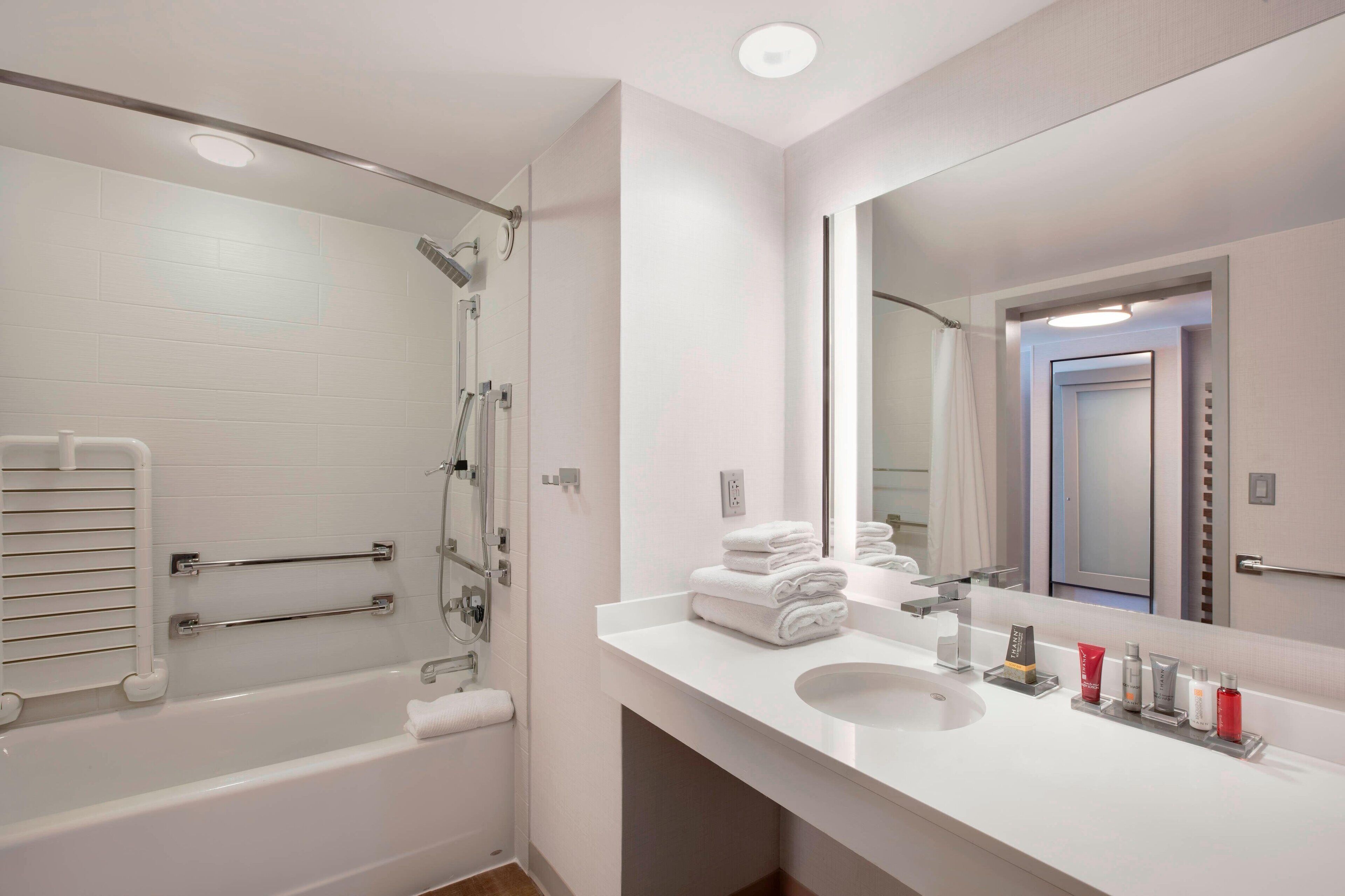 combined shower/bathtub, designer toiletries, hair dryer, towels