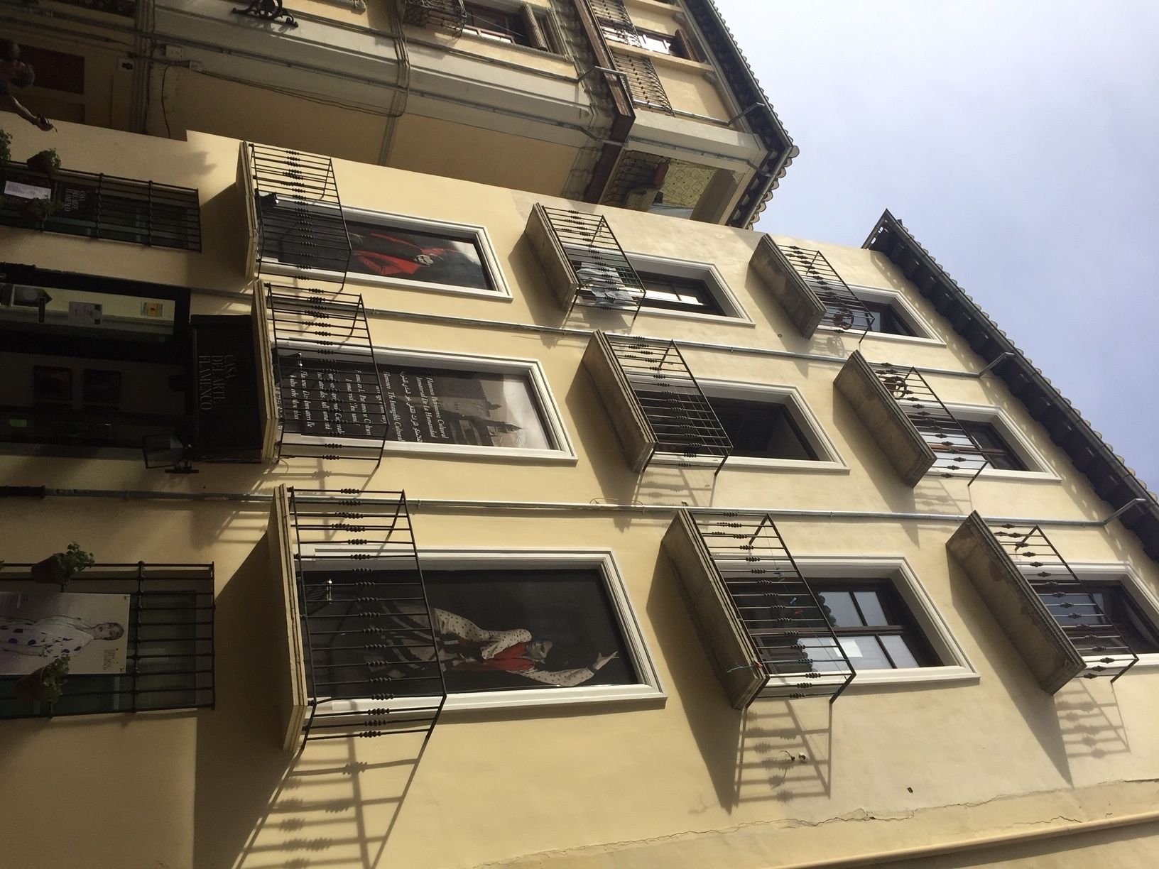 A multi-story building with multiple balconies and windows.