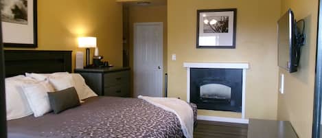 King Bedroom with Fireplace: Partial Ocean View | Premium bedding, down duvets, desk, iron/ironing board