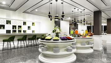 A modern hotel lobby with a bar area, green chairs, and a buffet with various food items.