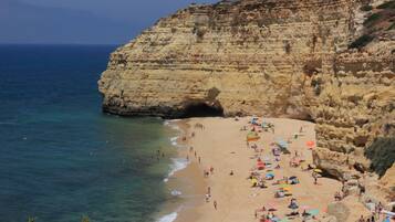 Enjoy the serene coastal scenery with a rugged cliff formation and calm ocean views.