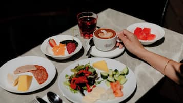 A table with various food items and a cup of coffee.