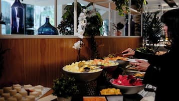 Un buffet proposant une variété de plats et agrémenté d'éléments décoratifs tels que des vases et des plantes.