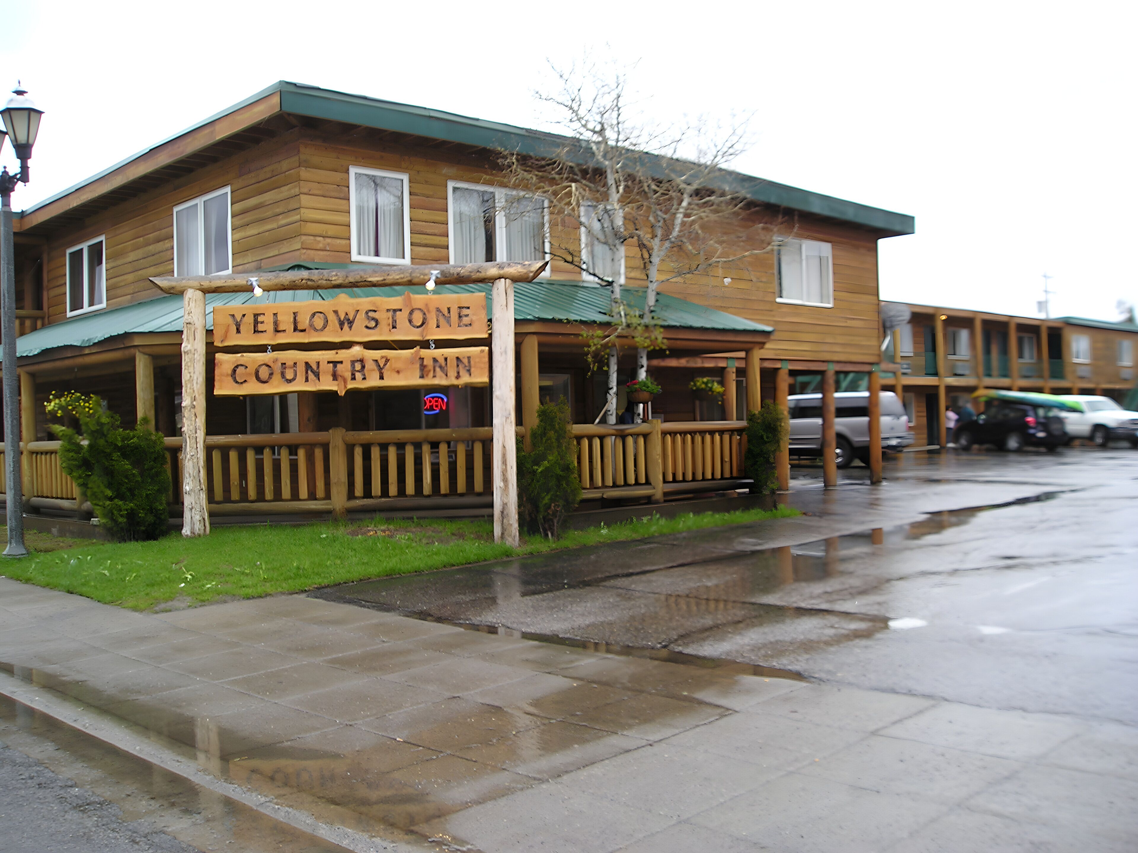 A wooden building with a sign reading "Yellowstone Country Inn."