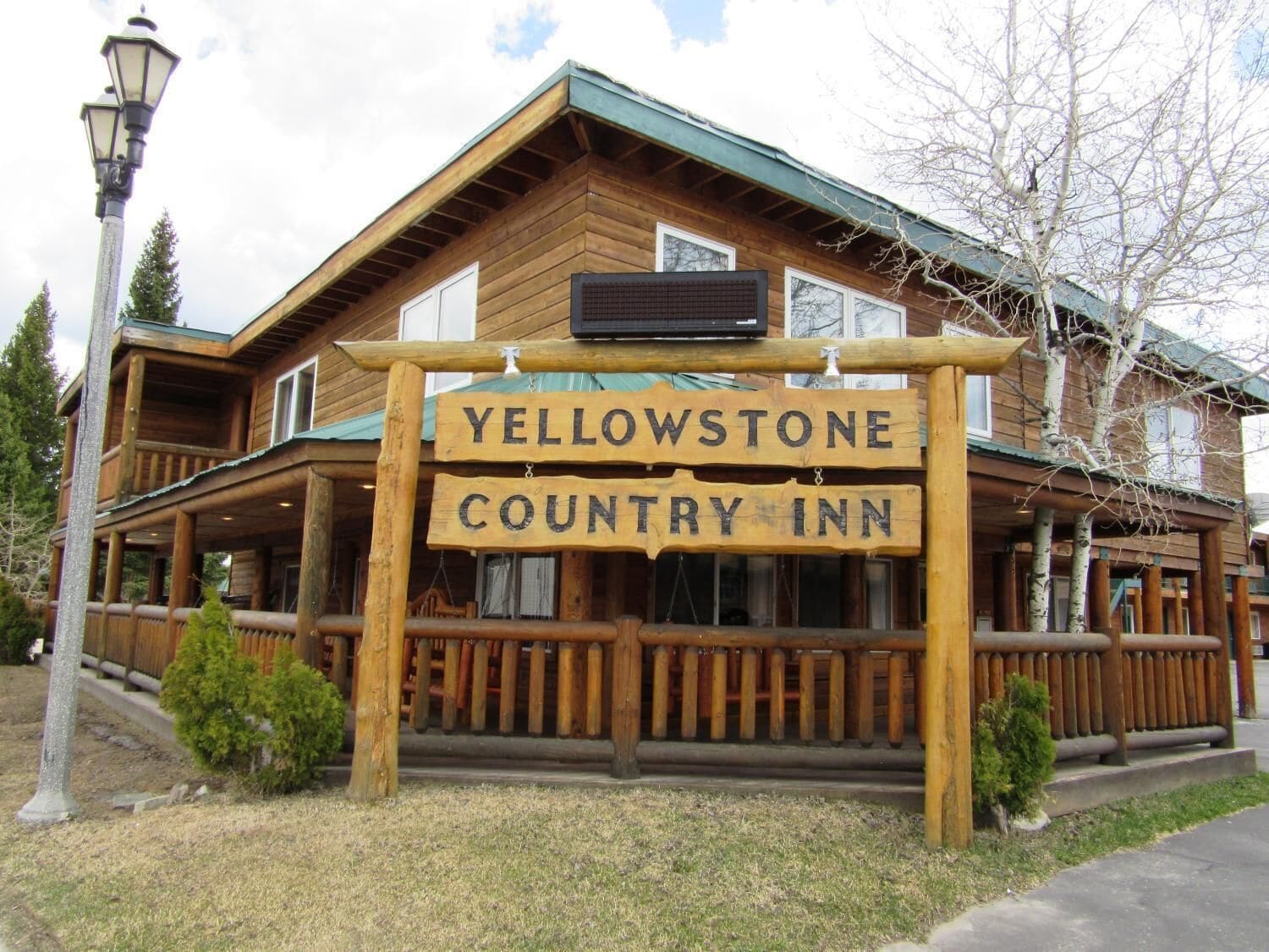 A wooden building with a sign reading "Yellowstone Country Inn".