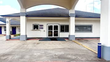 A building with a covered entrance, a door, and a window.