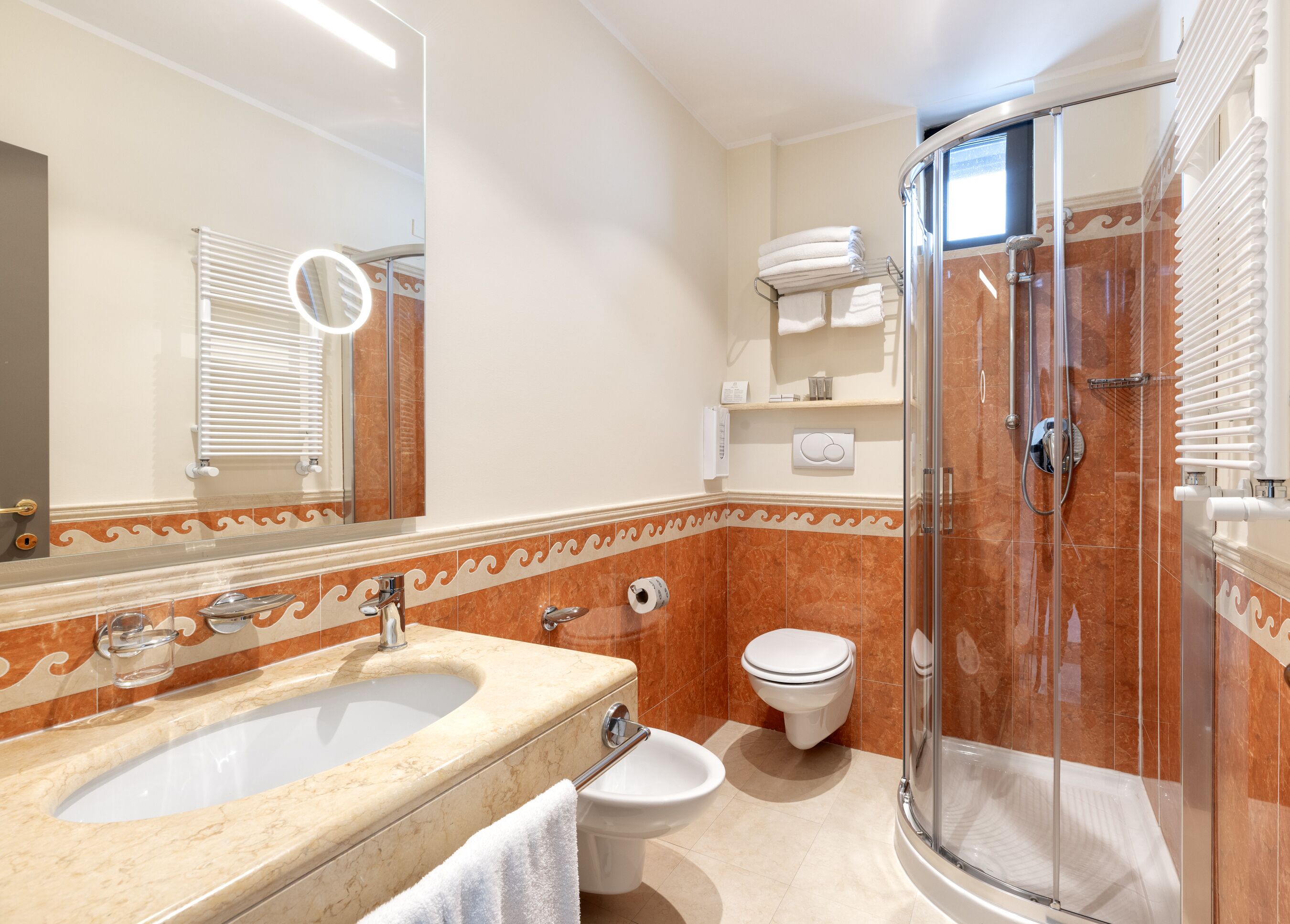 A bathroom with a sink, toilet, and shower.