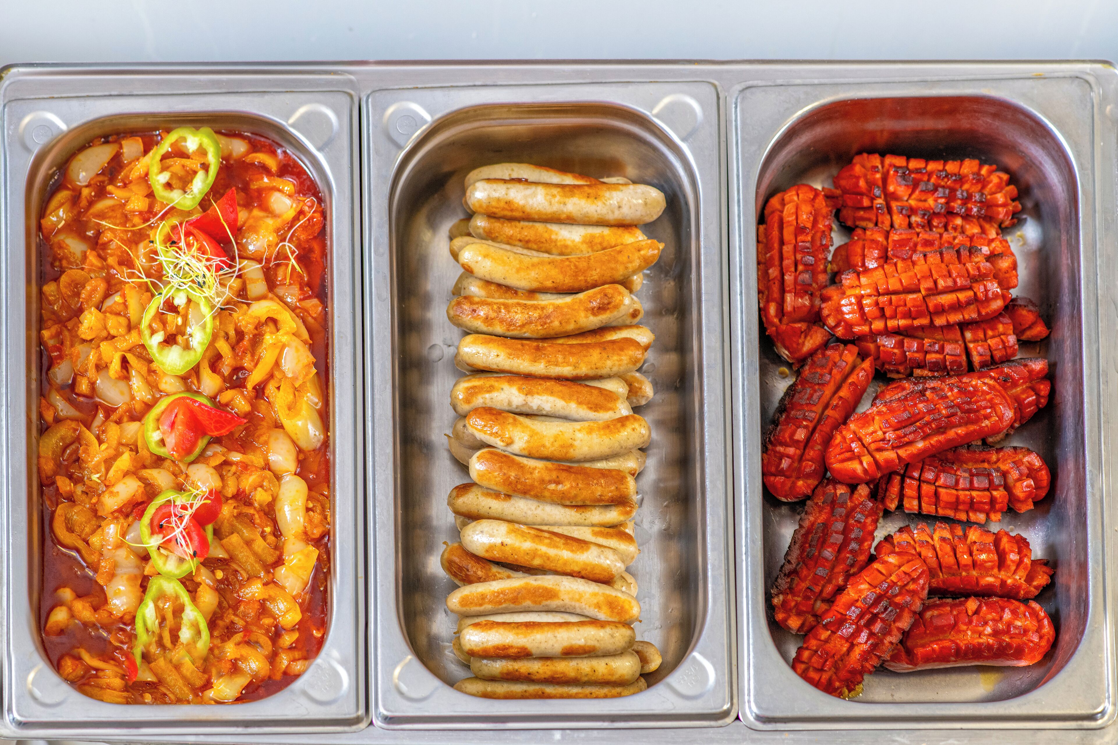 Three food trays with different dishes.