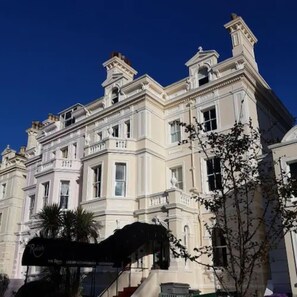 A large, classical building with multiple windows and a prominent entrance.