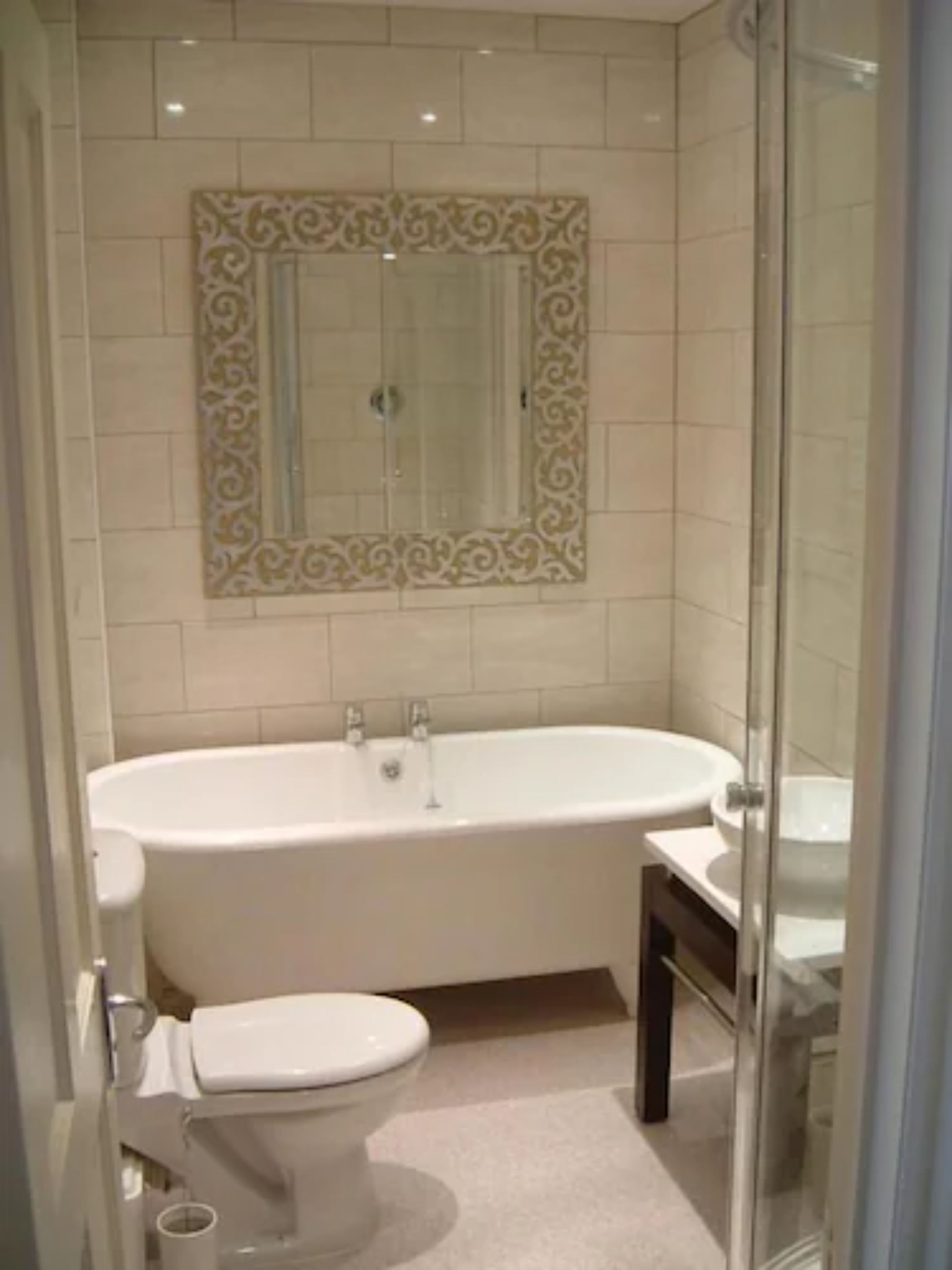 A bathroom with a freestanding bathtub, a toilet, and a glass shower enclosure.