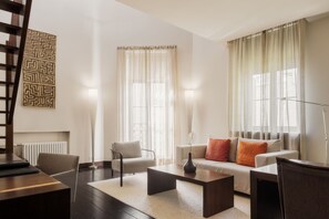 Relax in this stylish living room with a sofa, coffee table, and floor lamp.