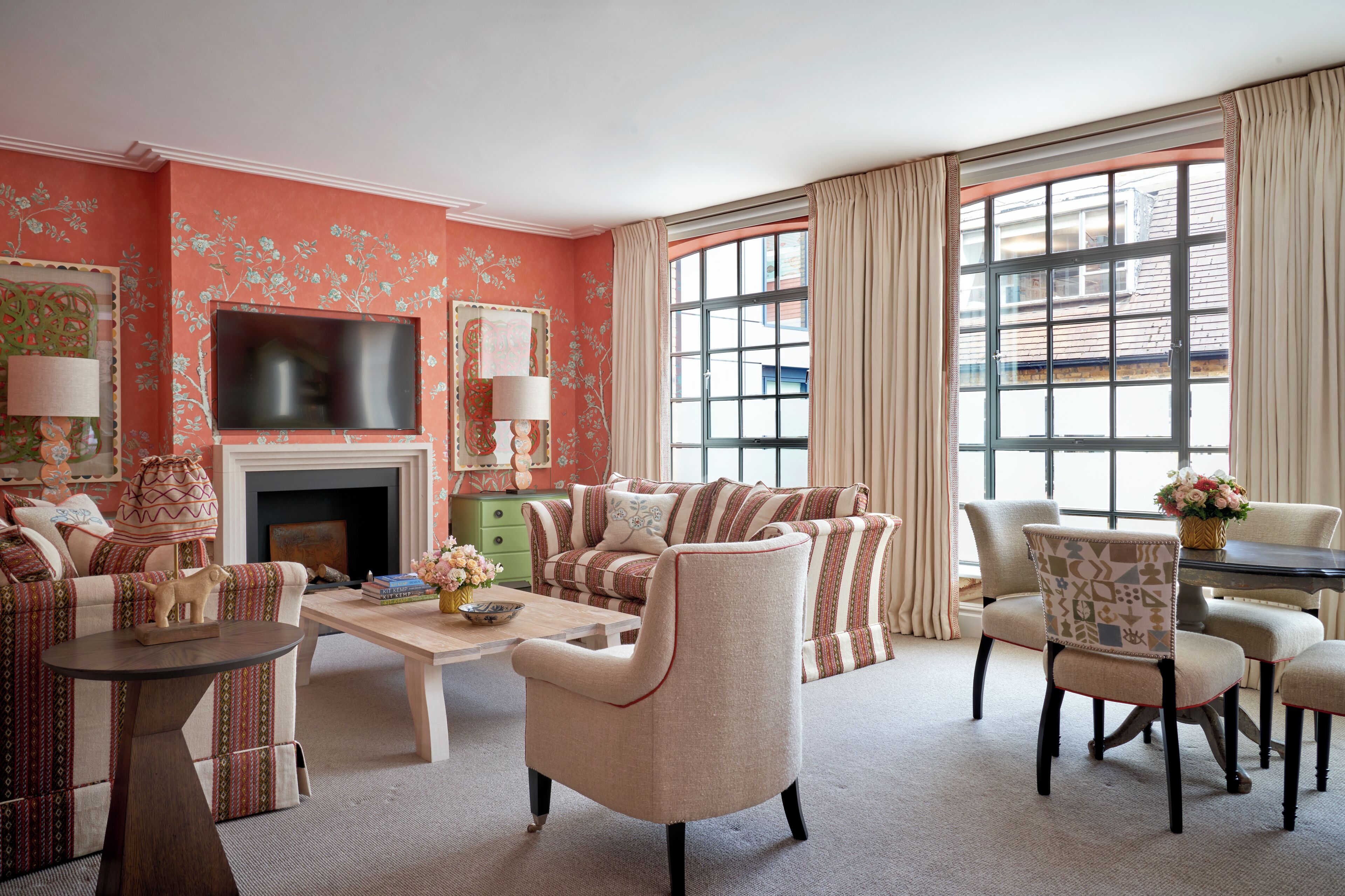 A living room with a sofa set, a coffee table, a fireplace, and a television.