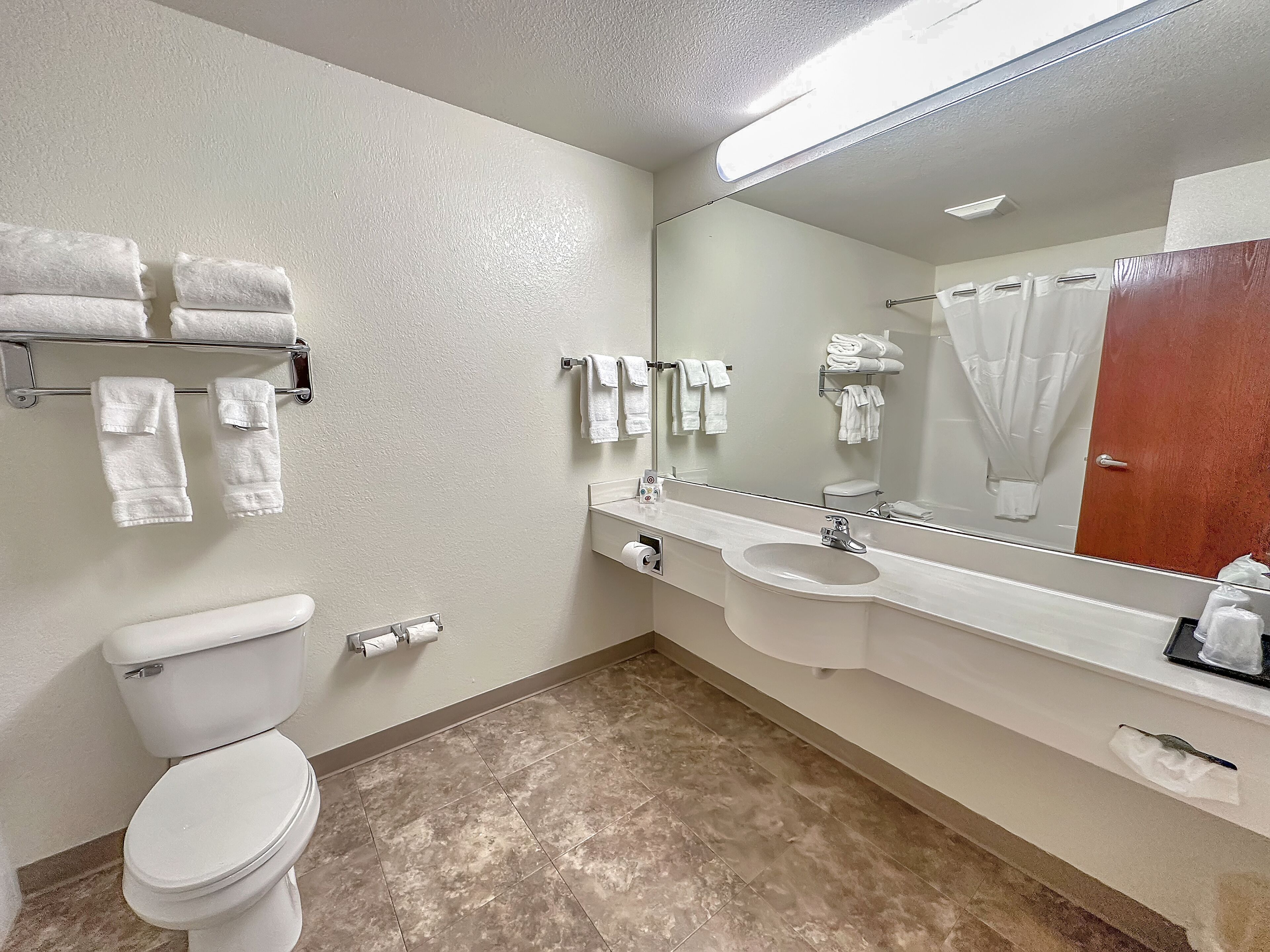 deluxe suite | bathroom | combined shower/bathtub, designer toiletries, hair dryer, towels