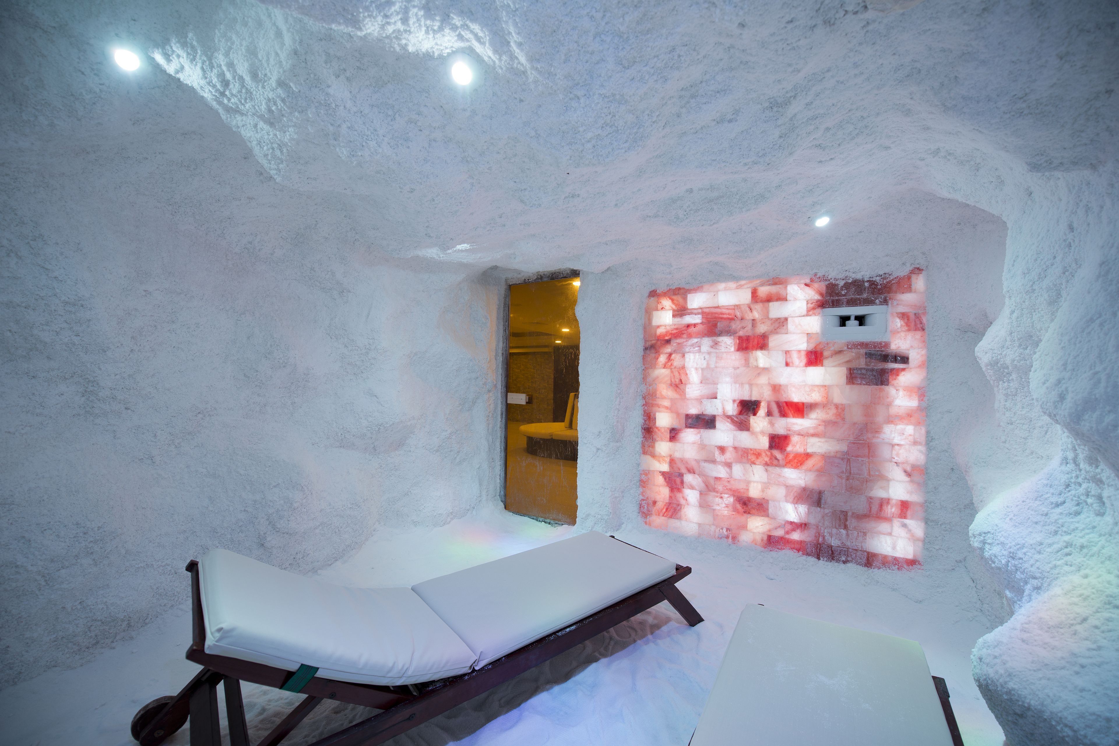 An ice sauna room with benches and a heated wall.